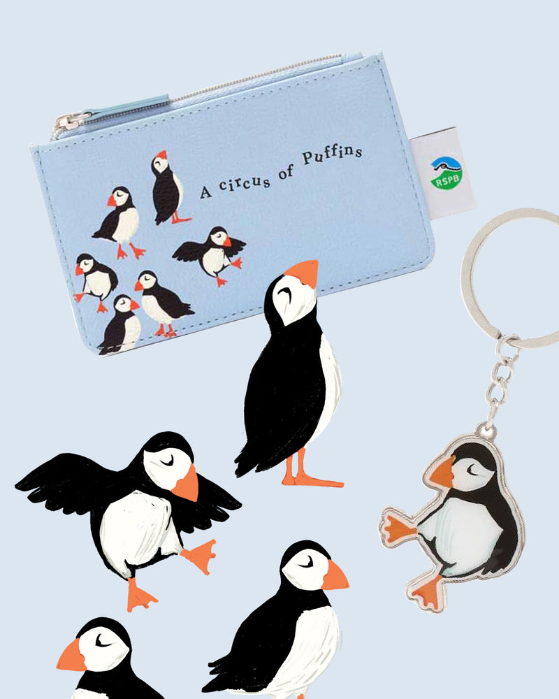 Pouch with puffin design and keychain on a light blue background